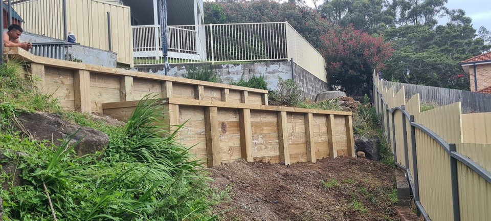 Stepped timber sleeper retaining wall built into a steep Wollongong slope
