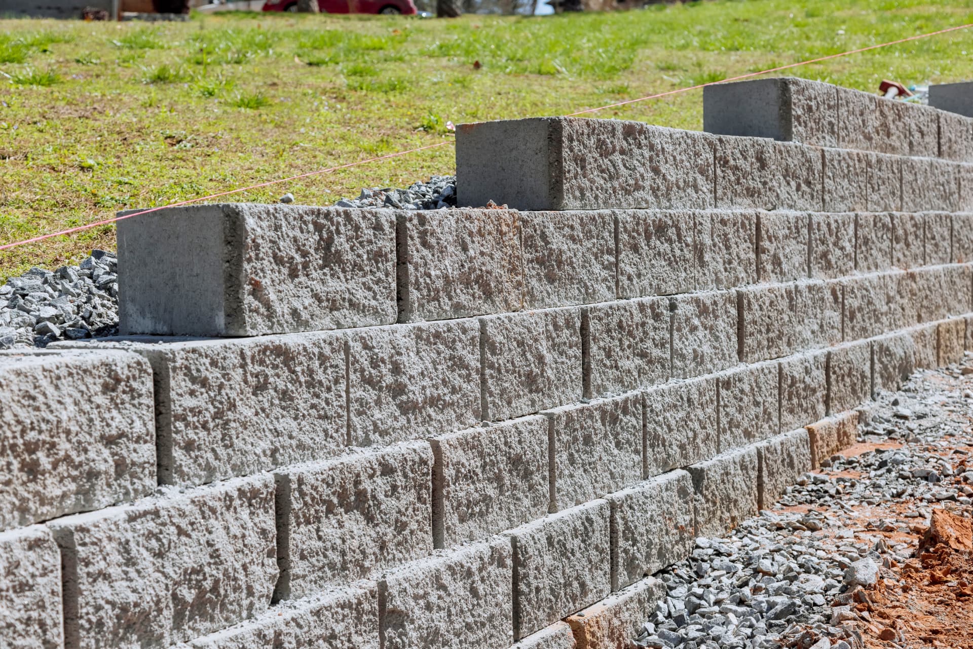 Textured grey concrete block retaining wall under construction by Retain by Theo in Wollongong