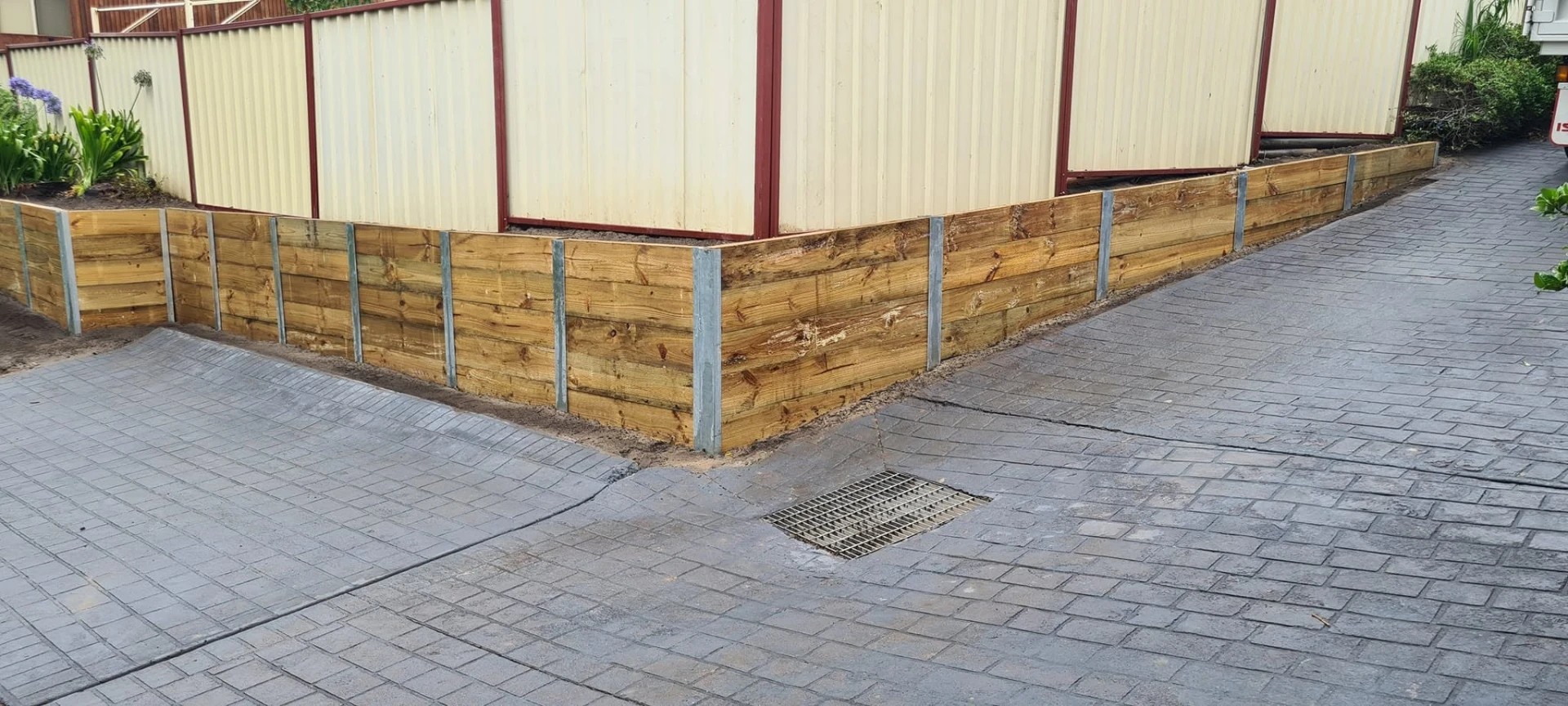 Retaining wall construction underway on a residential block in Figtree