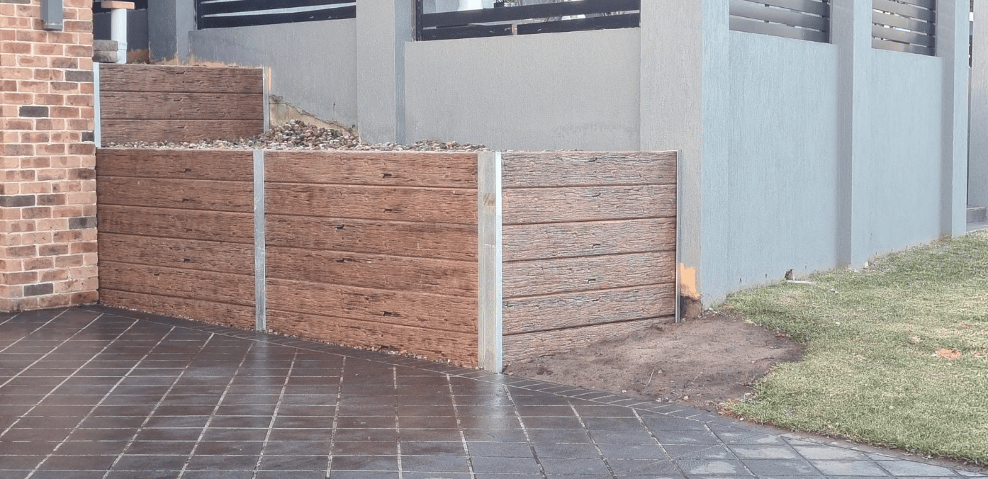 Finished retaining wall and landscaped yard completed by Retain by Theo in Stanwell Park