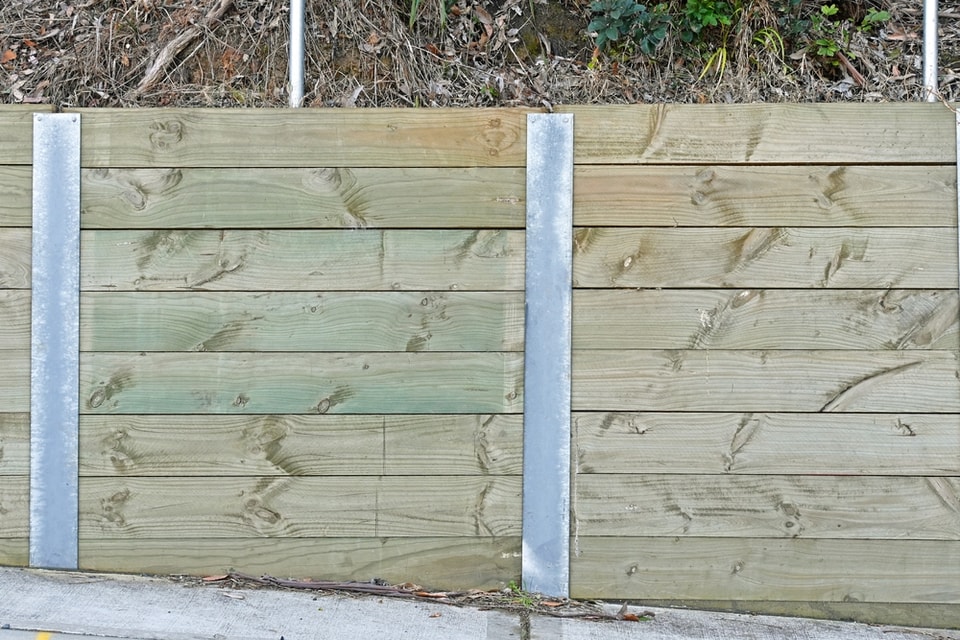 Treated timber sleeper retaining wall with galvanised steel posts in Thirroul