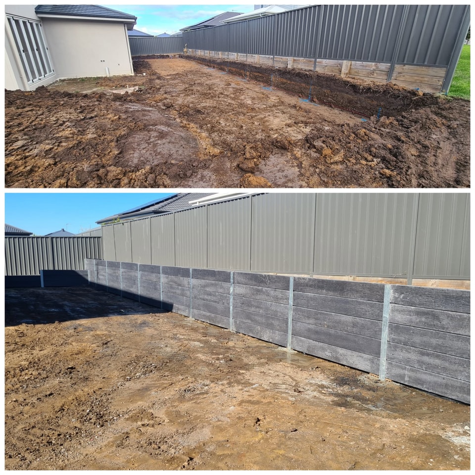 Grey timber-look concrete sleeper retaining wall along a Colorbond fence line