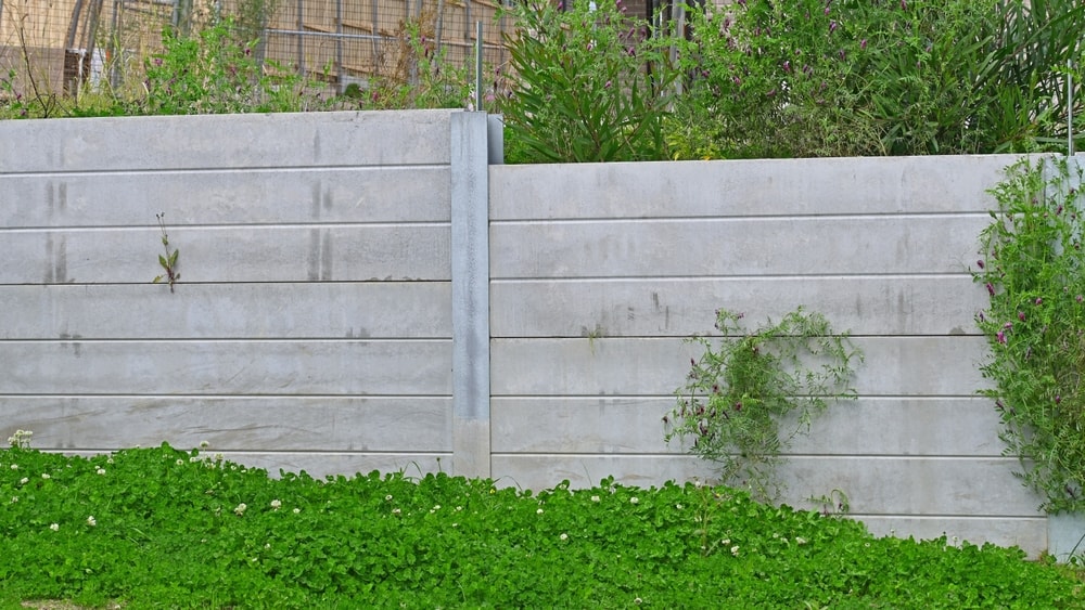 Close-up of concrete sleeper retaining walls finished on site by Retain by Theo