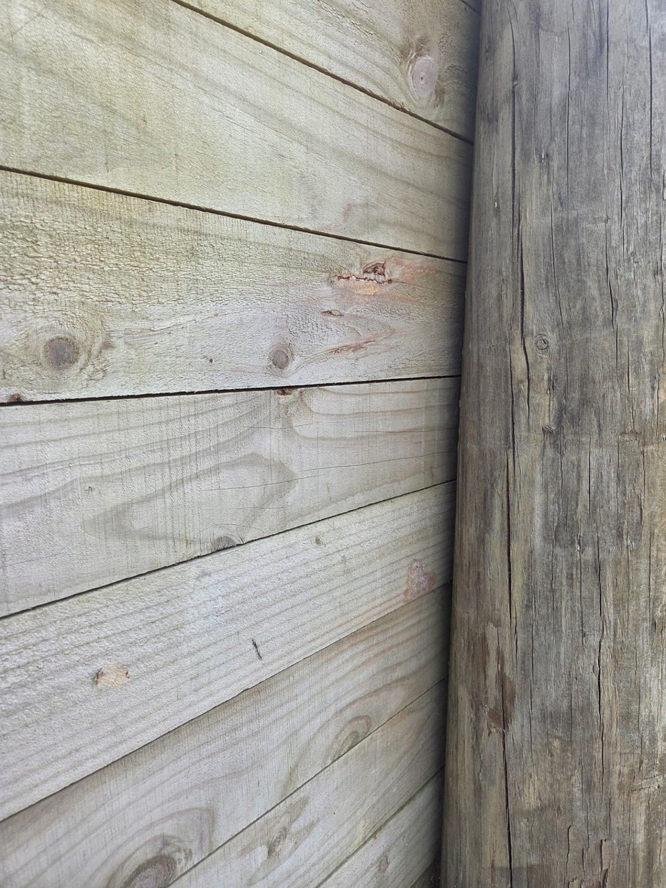 Treated timber sleeper retaining wall with a hardwood post in Balgownie