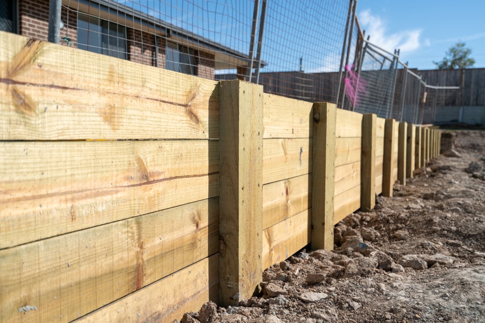 New treated timber sleeper retaining wall with timber posts on a Shellharbour build